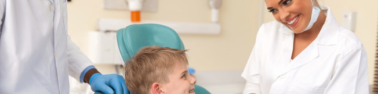 Dentist providing treatment for young patient.