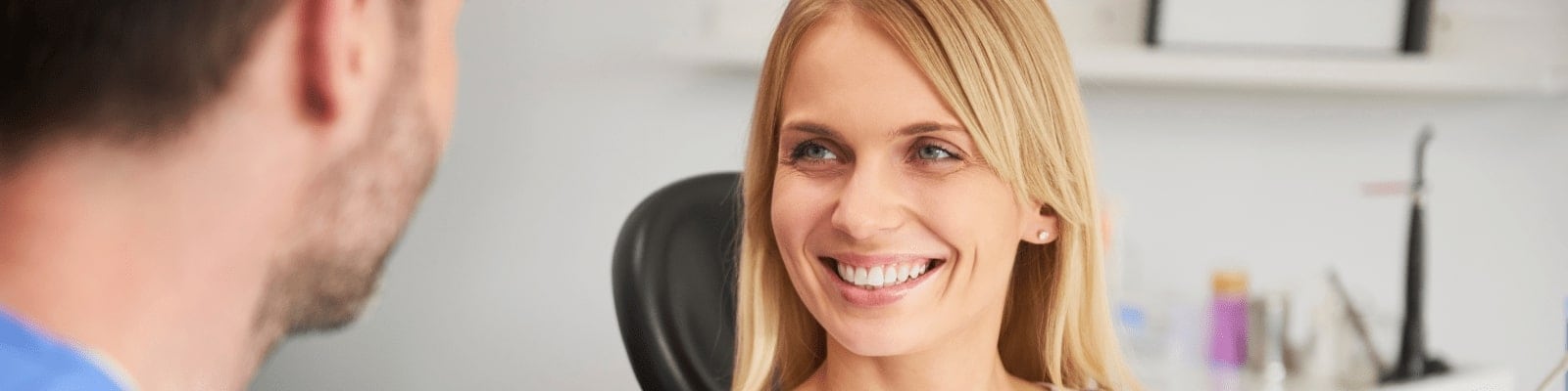 Smiling patient receiving dental treatment.