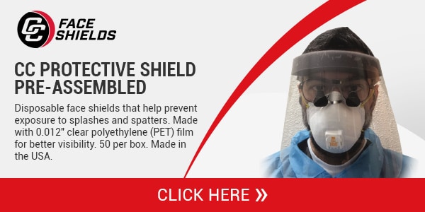 Dental Professional Wearing a Face Shield With Dental Loupes and Blue Scrubs